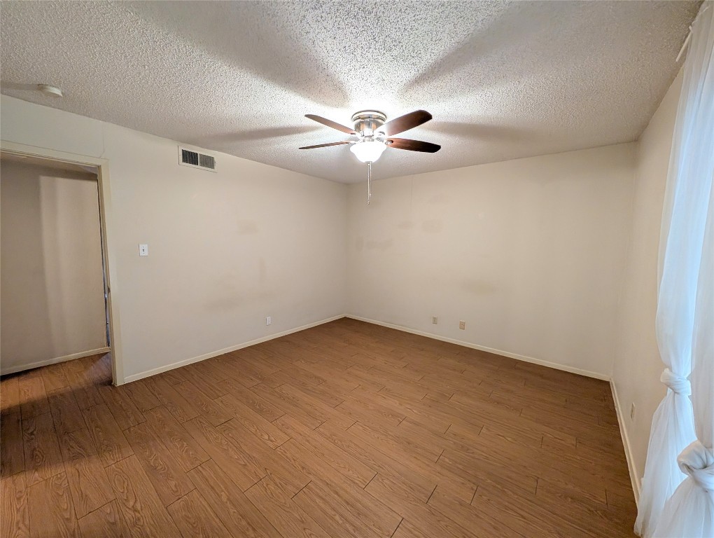 7801 Shoal Creek Boulevard, Unit 147 Austin, TX 78757 - Photo 8 of 15 wooden floor in an empty room