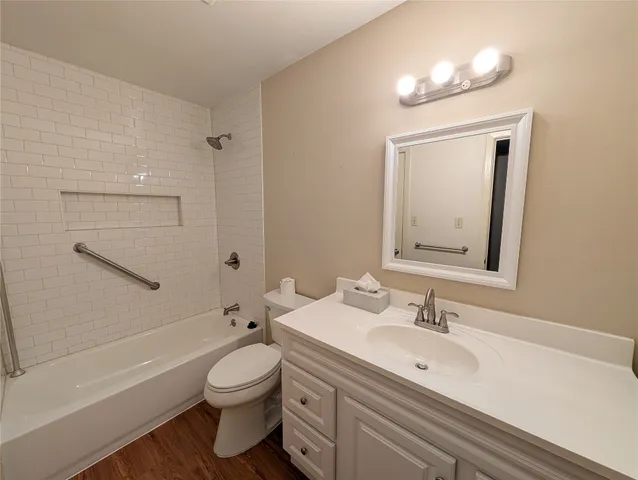 a bathroom with a toilet a sink a mirror and shower