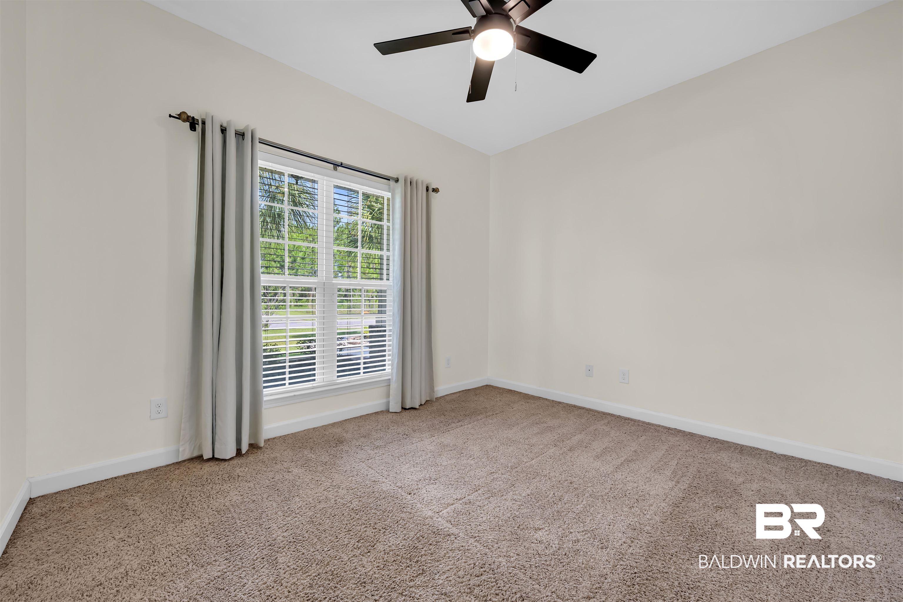 10147 Lyttleton Loop Lillian, AL 36549 - Photo 27 of 29 Carpeted room with a multi-pane window, white blinds, and light-colored walls