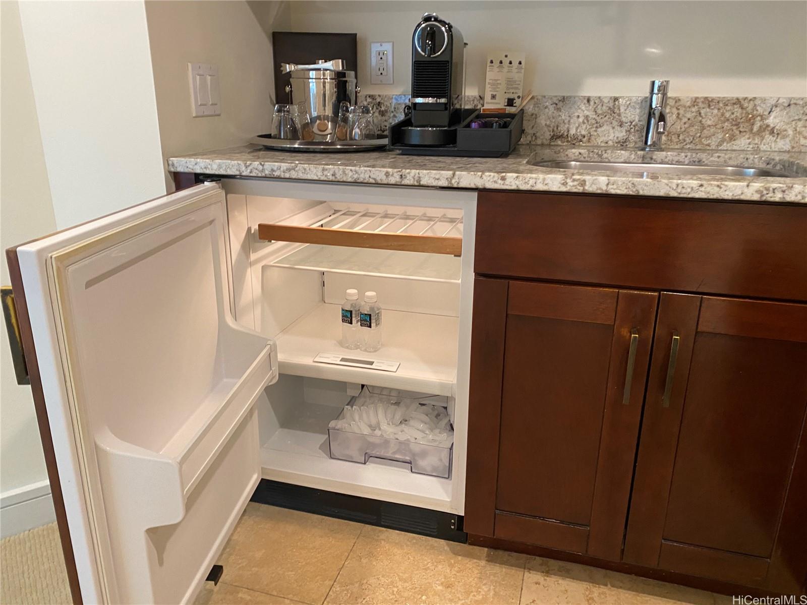 223 Saratoga Road, Unit 2316 Honolulu, HI 96815 - Photo 11 of 20 a bathroom with a granite countertop sink and a mirror