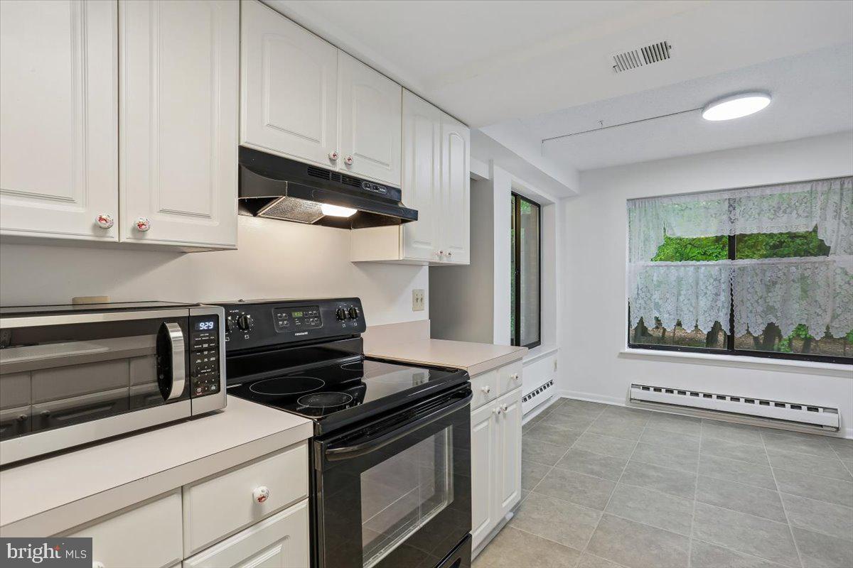 15210 Elkridge Way, Unit 912E Silver Spring, MD 20906 - Photo 13 of 48 a kitchen with stainless steel appliances a stove and a refrigerator