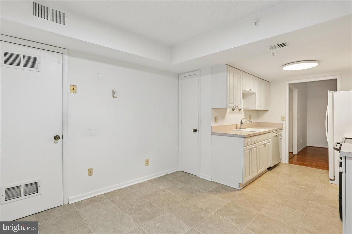 15210 Elkridge Way, Unit 912E Silver Spring, MD 20906 - Photo 17 of 48 a view of a kitchen with white cabinets