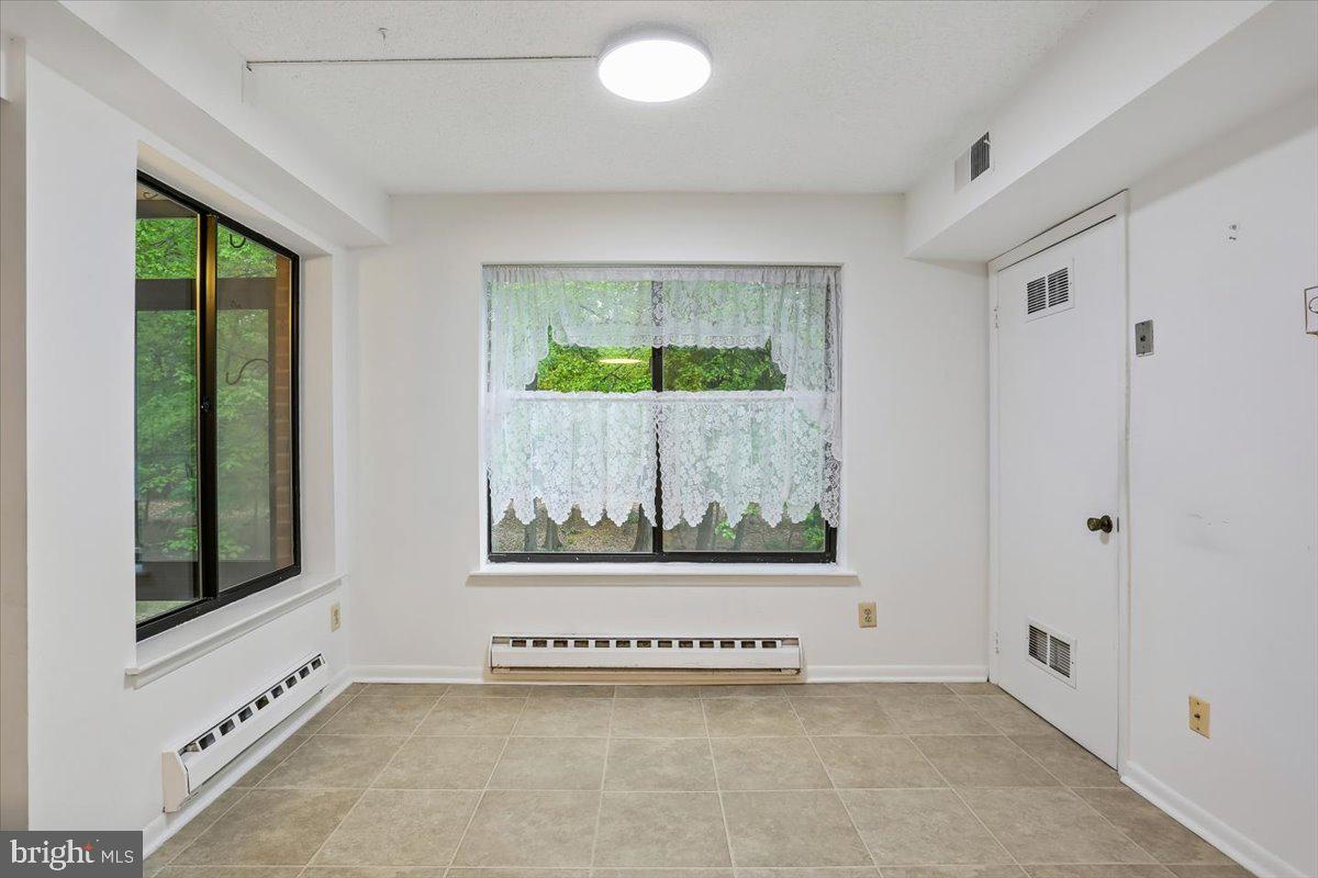 15210 Elkridge Way, Unit 912E Silver Spring, MD 20906 - Photo 18 of 48 an empty room with windows