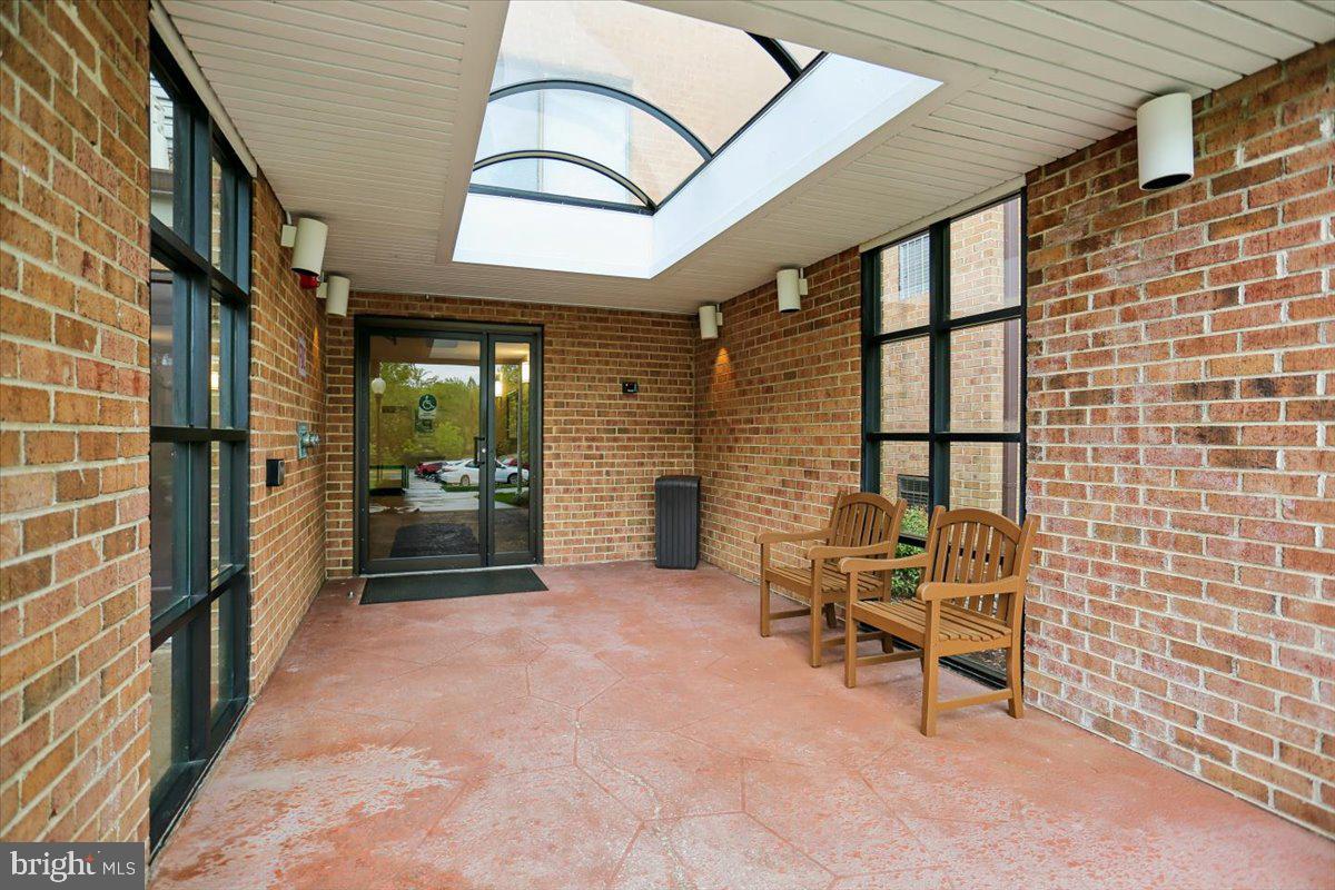 15210 Elkridge Way, Unit 912E Silver Spring, MD 20906 - Photo 2 of 48 a view of a brick house with chairs and table in a patio