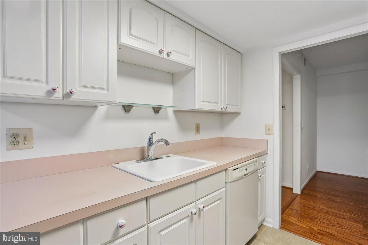 15210 Elkridge Way, Unit 912E Silver Spring, MD 20906 - Photo 22 of 48 a kitchen with white cabinets and a sink