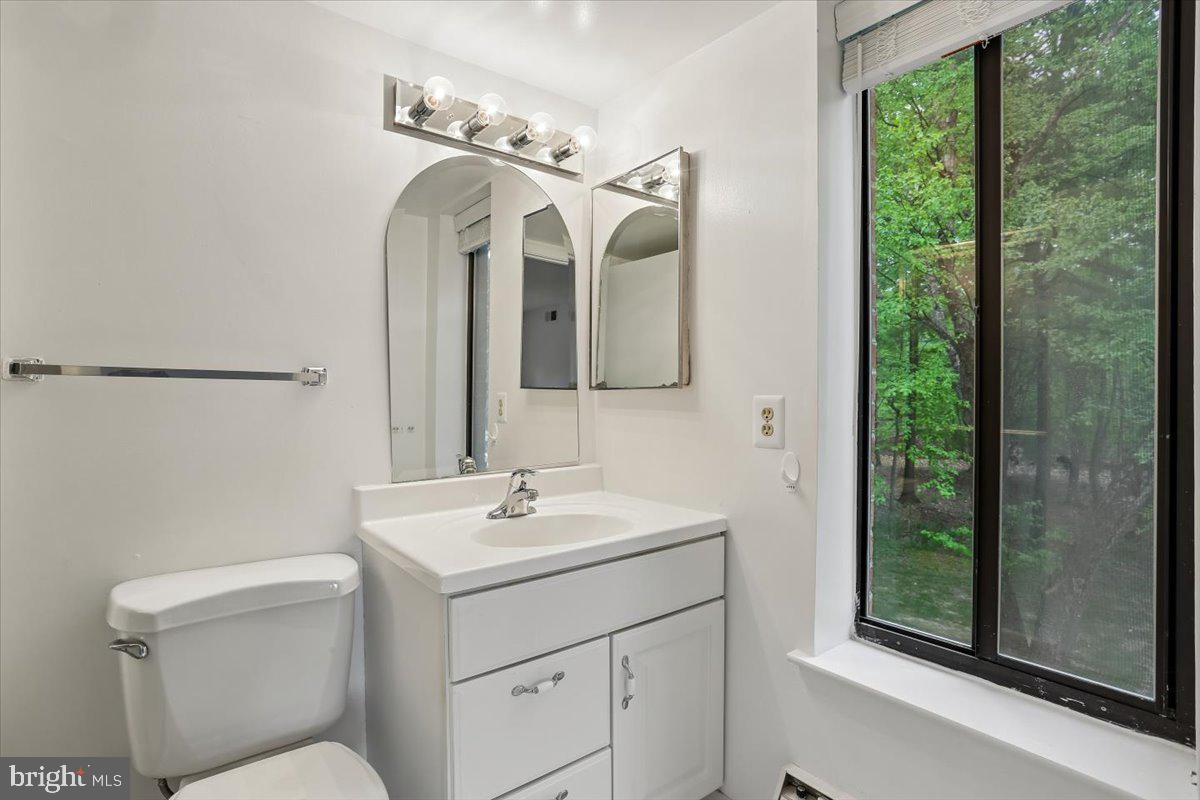 15210 Elkridge Way, Unit 912E Silver Spring, MD 20906 - Photo 30 of 48 a bathroom with a toilet sink and mirror