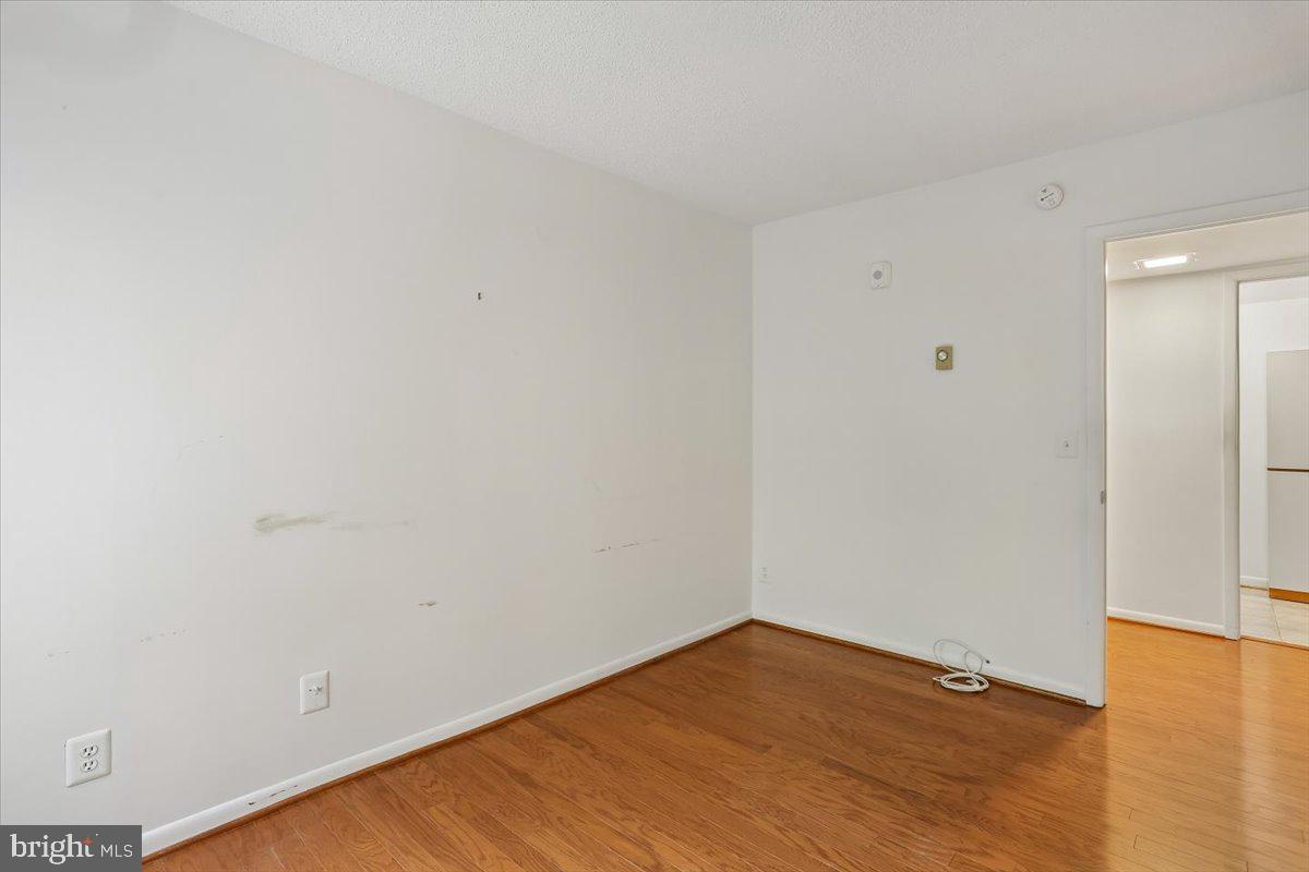 15210 Elkridge Way, Unit 912E Silver Spring, MD 20906 - Photo 36 of 48 a view of an empty room with wooden floor