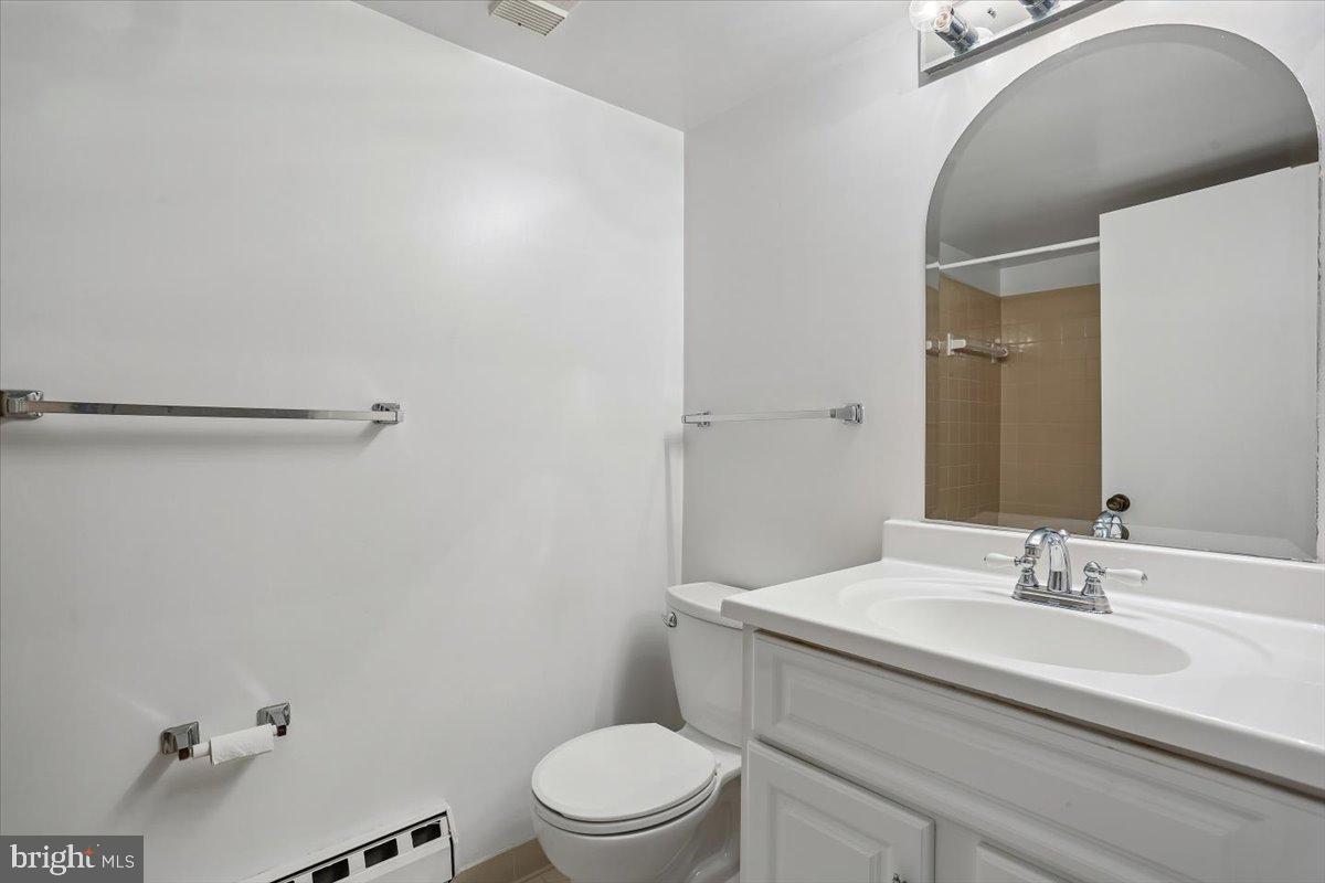 15210 Elkridge Way, Unit 912E Silver Spring, MD 20906 - Photo 39 of 48 a bathroom with a sink mirror vanity and toilet