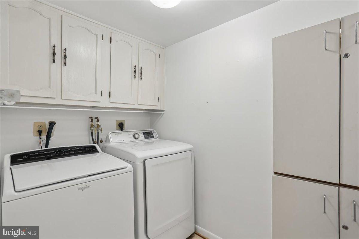 15210 Elkridge Way, Unit 912E Silver Spring, MD 20906 - Photo 41 of 48 a view of storage and utility room with washer and dryer