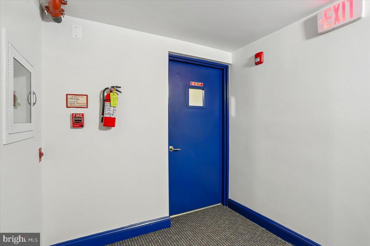 15210 Elkridge Way, Unit 912E Silver Spring, MD 20906 - Photo 43 of 48 a utility room with a refrigerator and wooden floor