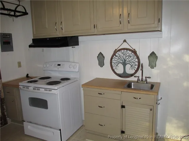 a kitchen with a stove and cabinets