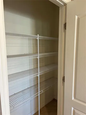 a view of a room with wooden floor and natural light