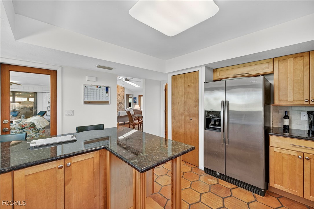 5307 Ladyfinger Lake Road Sanibel, FL 33957 - Photo 16 of 45 a kitchen with stainless steel appliances granite countertop a refrigerator a stove and a sink with granite countertops