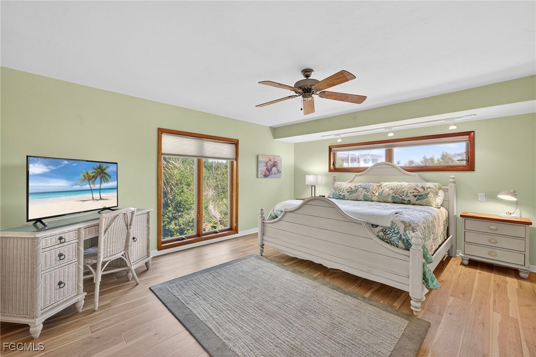 5307 Ladyfinger Lake Road Sanibel, FL 33957 - Photo 20 of 45 a bedroom with a large bed and a flat tv screen on dresser