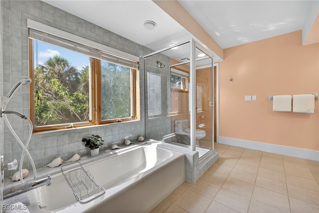 5307 Ladyfinger Lake Road Sanibel, FL 33957 - Photo 23 of 45 a bathroom with a tub a sink and a large window