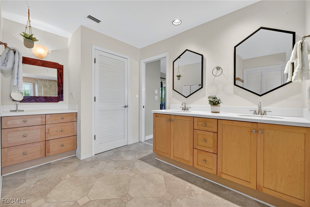 5307 Ladyfinger Lake Road Sanibel, FL 33957 - Photo 24 of 45 a bathroom with a double vanity sink and a mirror