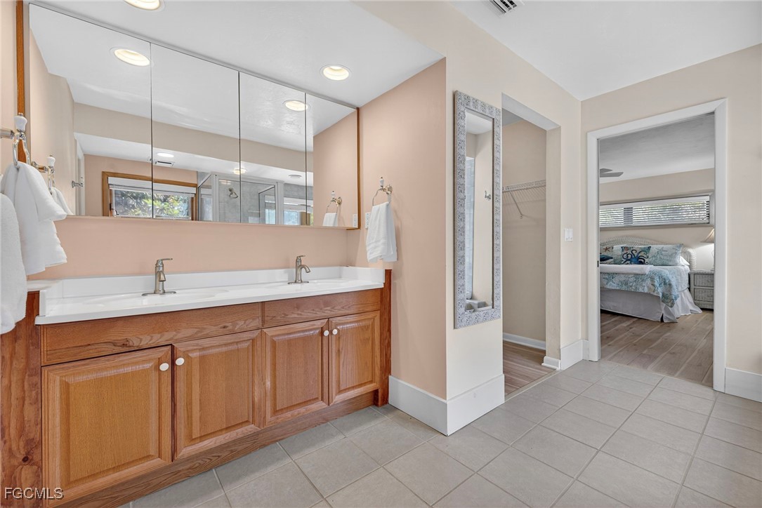 5307 Ladyfinger Lake Road Sanibel, FL 33957 - Photo 30 of 45 a spacious bathroom with a shower sink and mirror