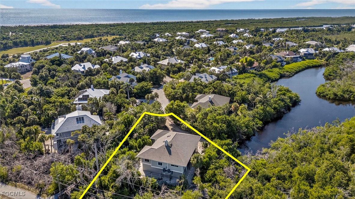 5307 Ladyfinger Lake Road Sanibel, FL 33957 - Photo 37 of 45 an aerial view of a house with a yard and lake view
