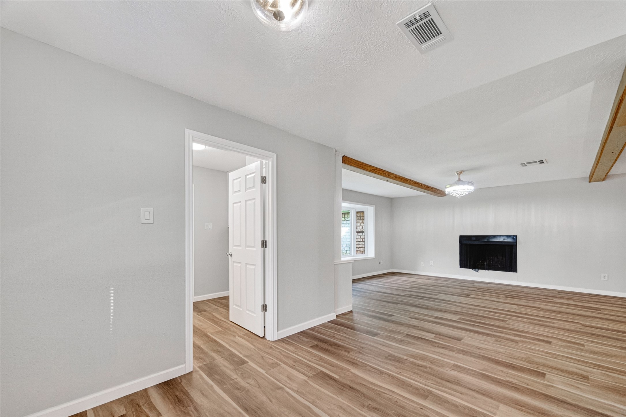 25503 Foxbriar Lane Spring, TX 77373 - Photo 14 of 45 a view of an empty room with wooden floor and a window