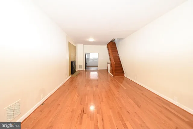 a view of a hallway with wooden floor