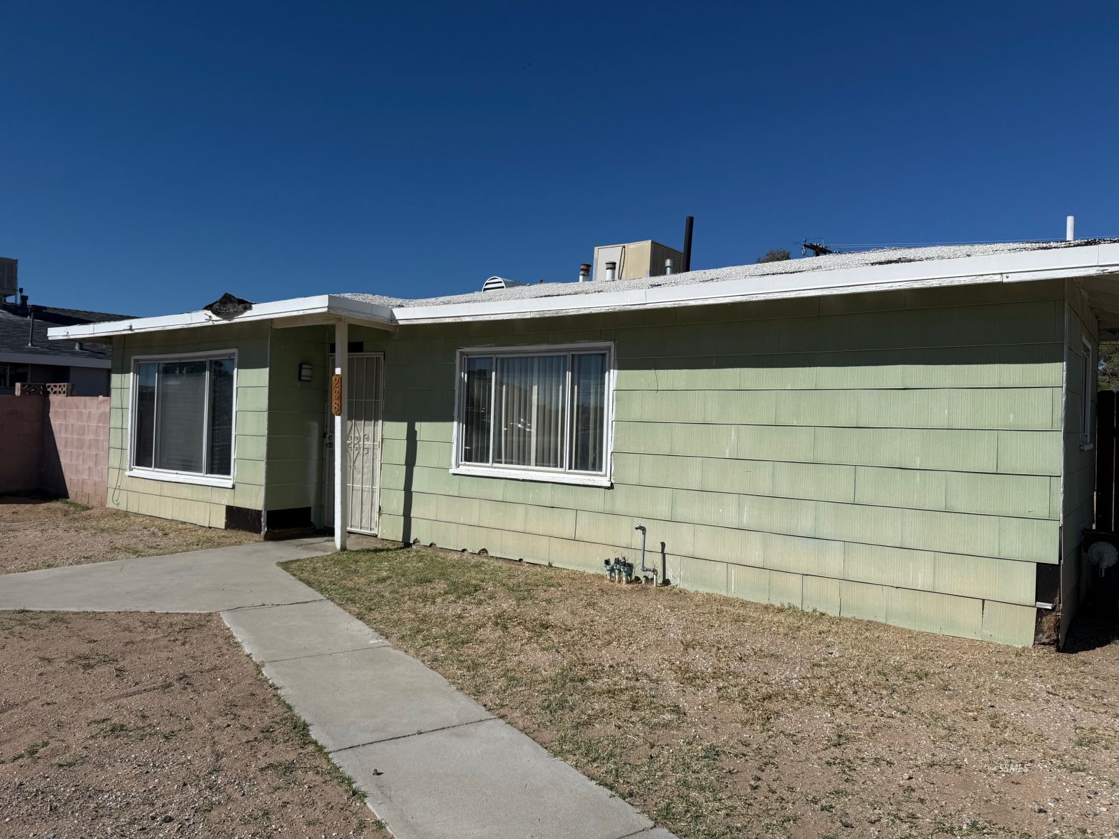 238 West Church Avenue Ridgecrest, CA 93555 - Photo 1 of 20 a front view of a house with a yard
