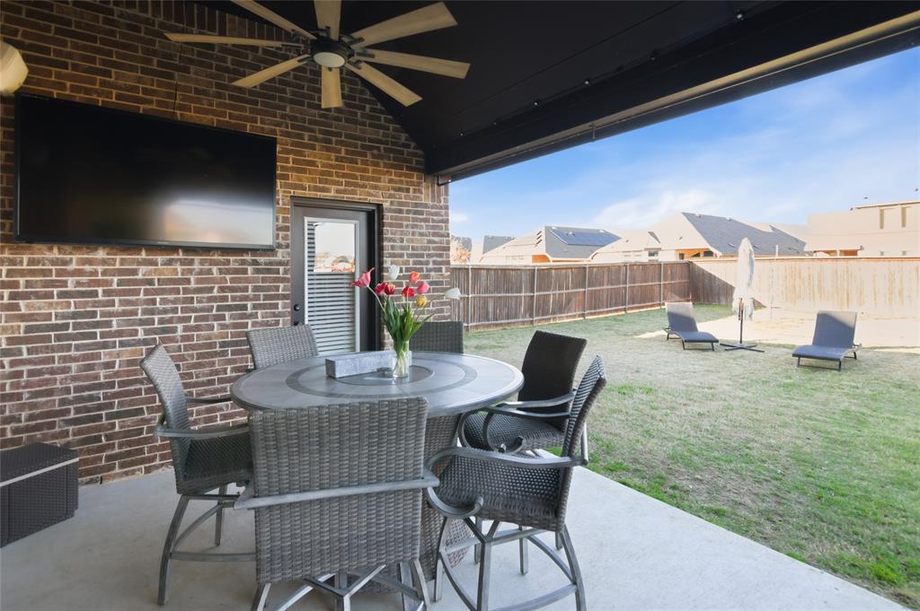 464 LeTara Ranch Drive Haslet, TX 76052 - Photo 30 of 37 Covered patio with a high vaulted ceiling, exposed brick wall, and concrete flooring