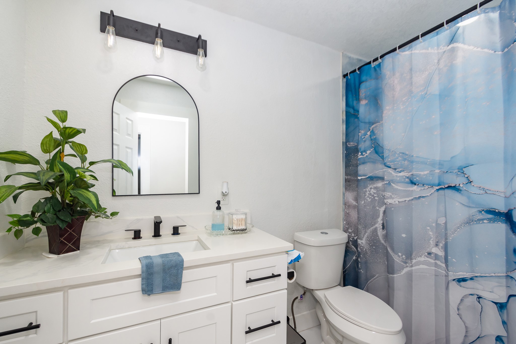 2930 West Shane Street Alvin, TX 77511 - Photo 11 of 19 a bathroom with a toilet sink and mirror
