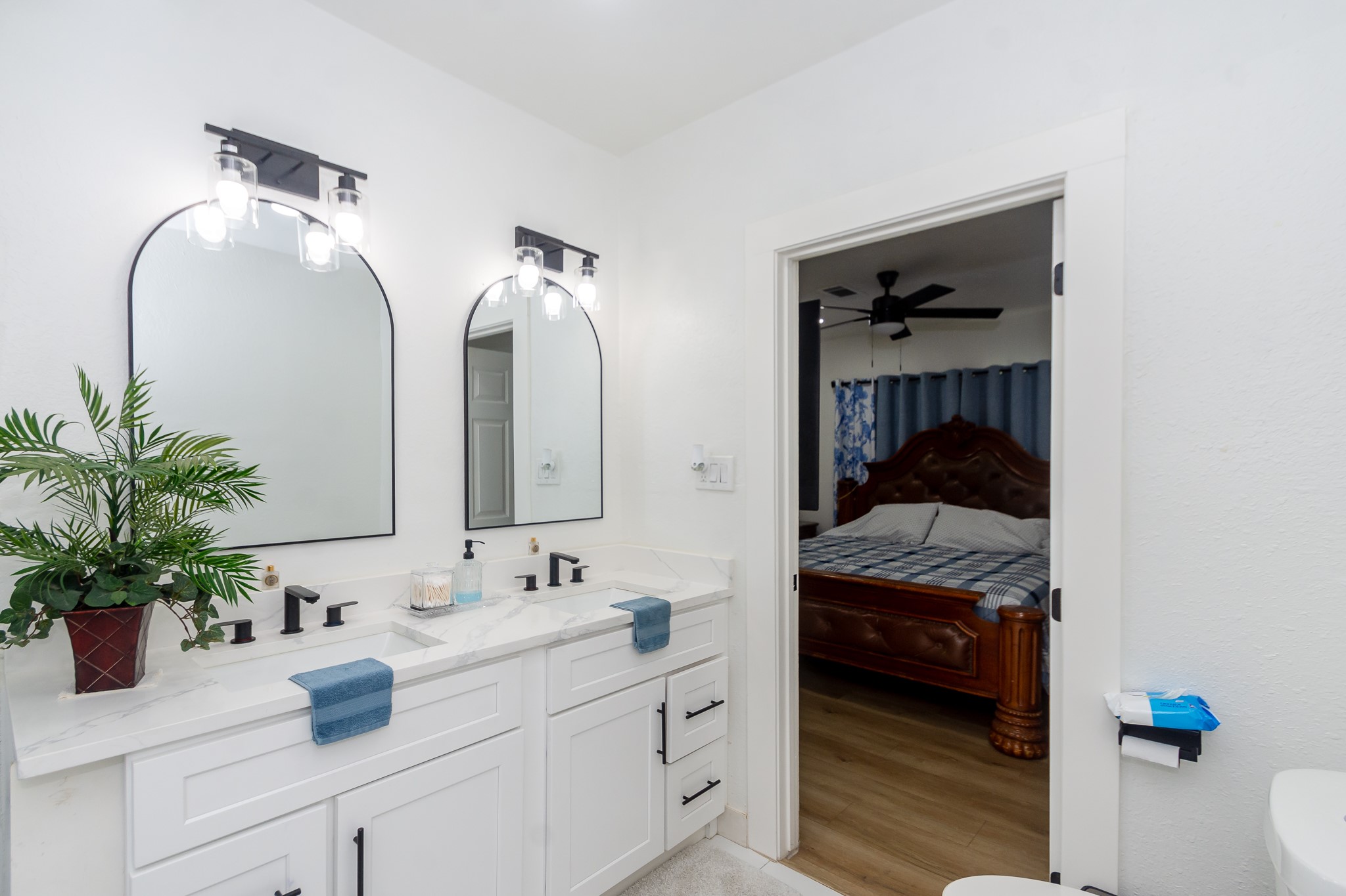 2930 West Shane Street Alvin, TX 77511 - Photo 13 of 19 a en suite bathroom with a granite countertop sink and a mirror