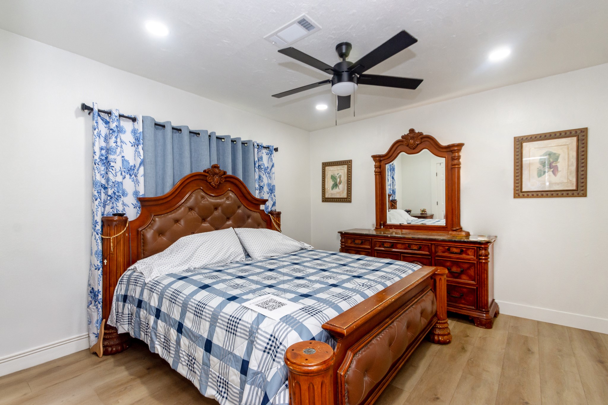 2930 West Shane Street Alvin, TX 77511 - Photo 14 of 19 a bedroom with a bed and a chandelier