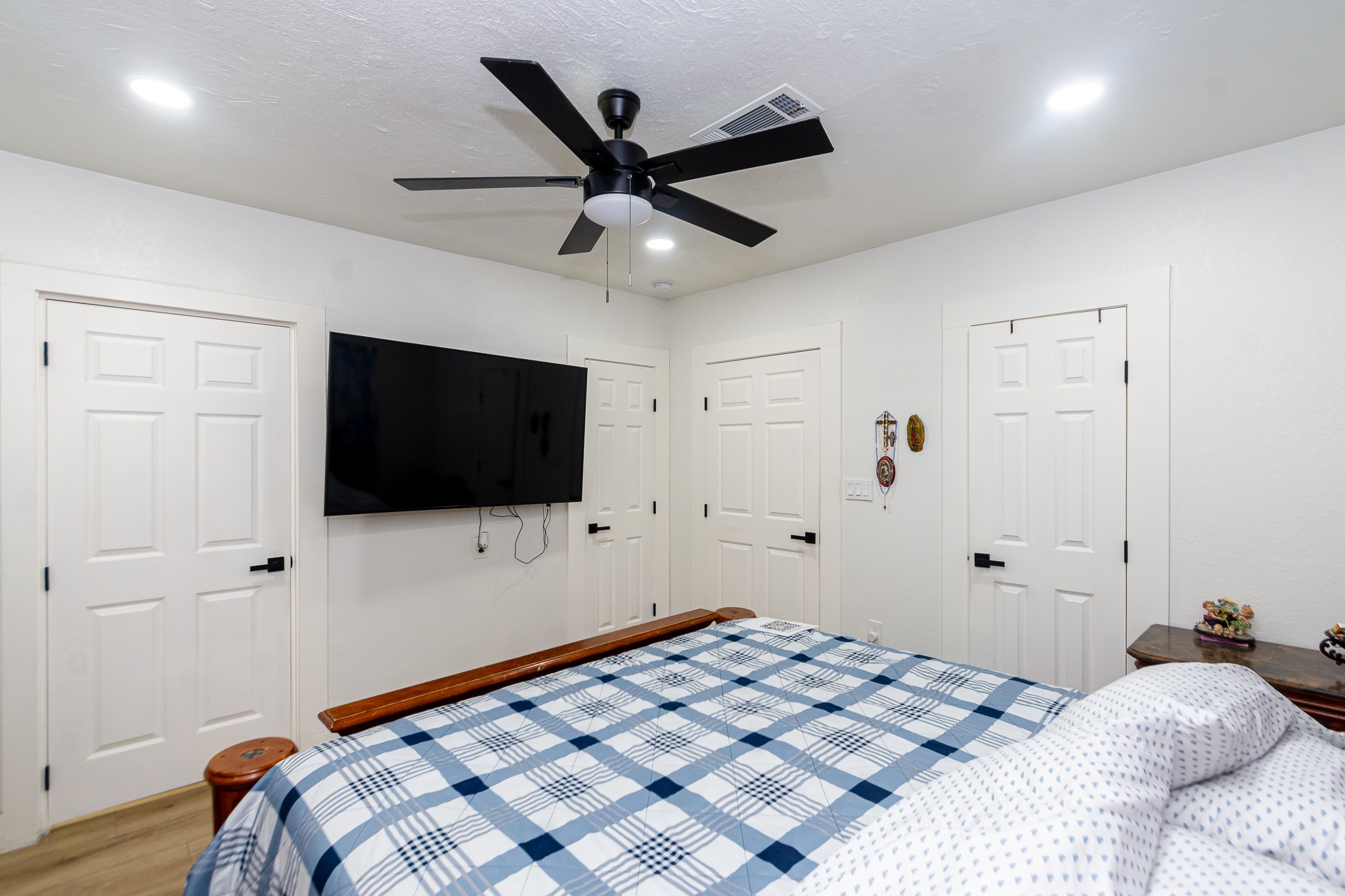 2930 West Shane Street Alvin, TX 77511 - Photo 15 of 19 a bedroom with a bed and a flat screen tv