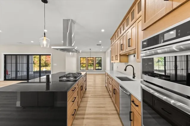 a kitchen with stainless steel appliances granite countertop a stove and a sink