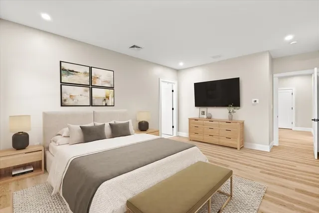 a hotel room with two bed and a flat screen tv