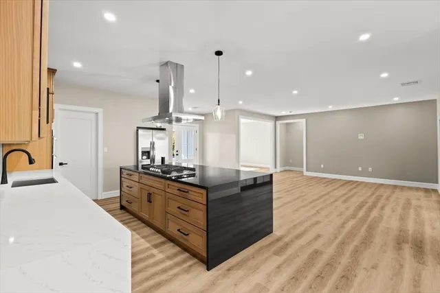 a kitchen with stainless steel appliances granite countertop a stove and a sink with granite countertops