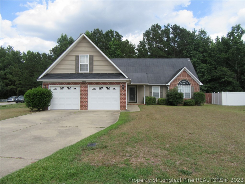 a house with green field in front of it