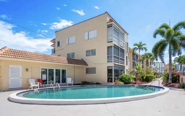 331 Southwest 8th Street, Unit 2CE Boca Raton, FL 33432 - Photo 1 of 19 a front view of house with yard and green space
