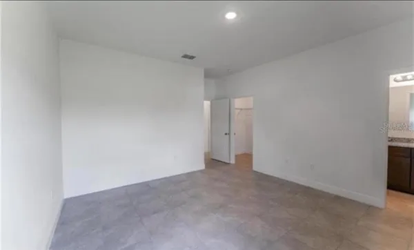 a bathroom with a granite countertop toilet a sink and a bathtub