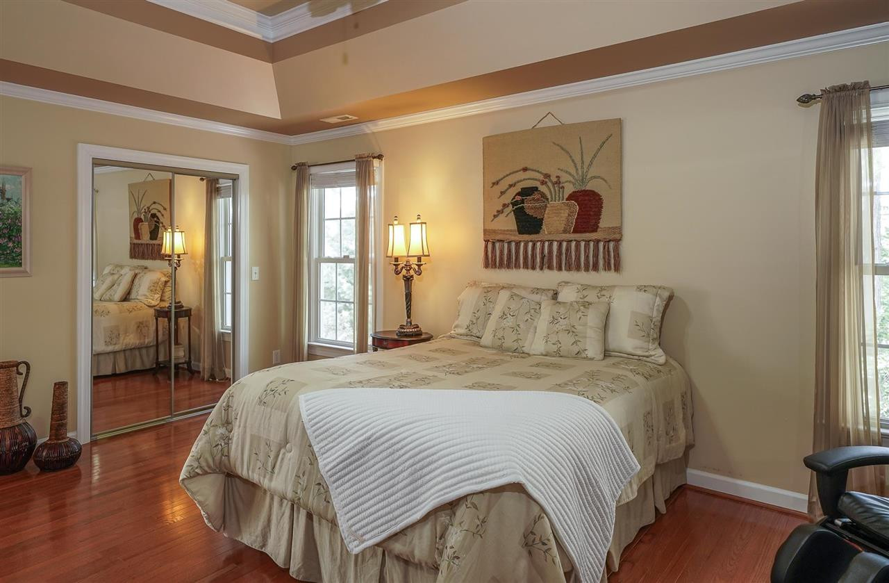 6000 Tiffield Way Wake Forest, NC 27587 - Photo 17 of 30 Large Owner's Suite with tray ceiling, hardwood floors, Large walk-in closet with mirrors on the doors. Owner's Suite