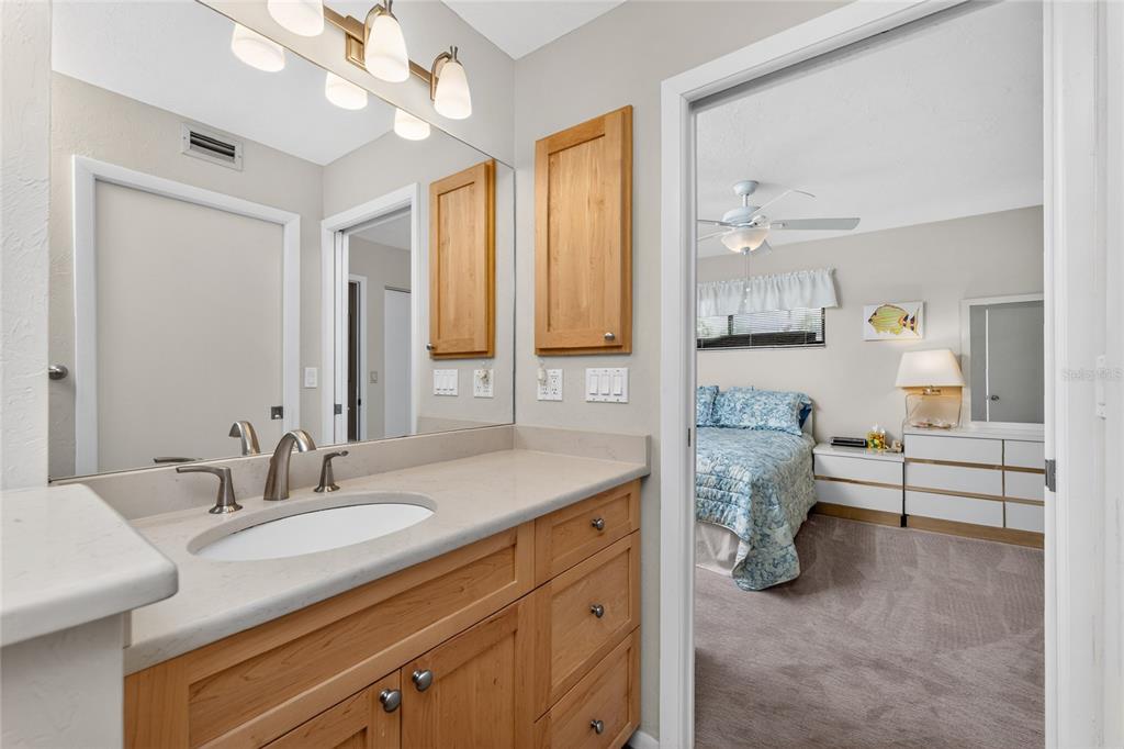 2955 North Beach Road, Unit B614 Englewood, FL 34223 - Photo 29 of 67 a spacious bathroom with a granite countertop sink and a mirror