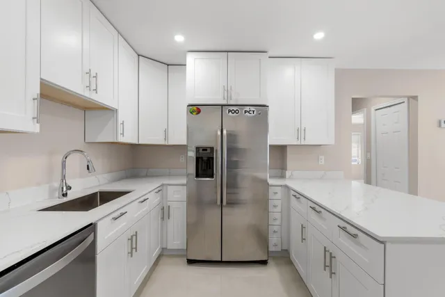 a view of a big room with windows and chandelier fan