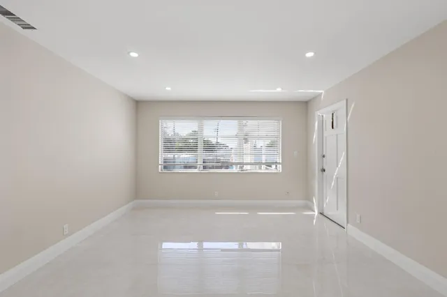 a view of kitchen with refrigerator and window