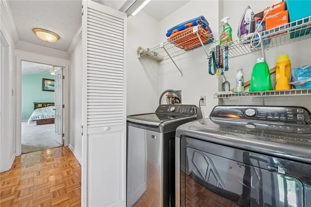 a utility room with stainless steel appliances granite countertop a sink and a stove