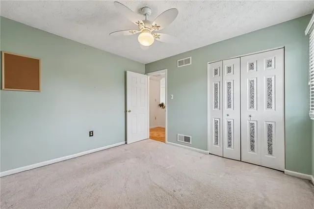 a view of an empty room with a ceiling fan