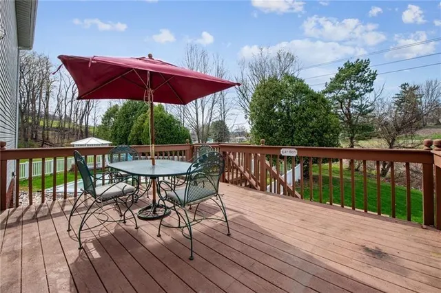 a view of balcony with wooden floor and outdoor seating