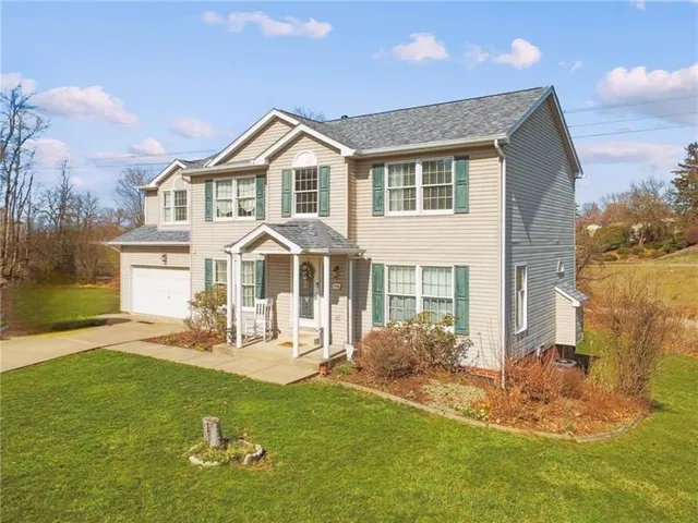 a front view of a house with a garden and patio