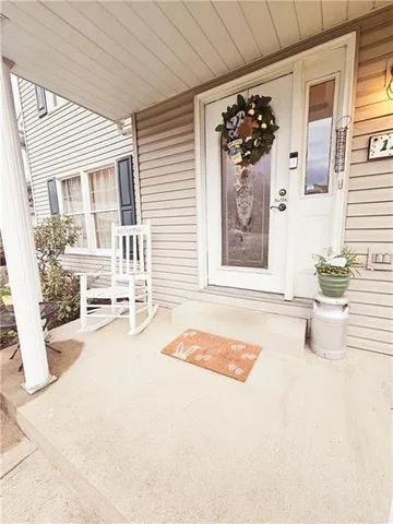 a view of a livingroom with wooden floor and furniture