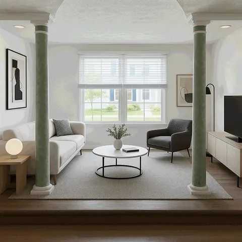 a living room with furniture fireplace and a large window