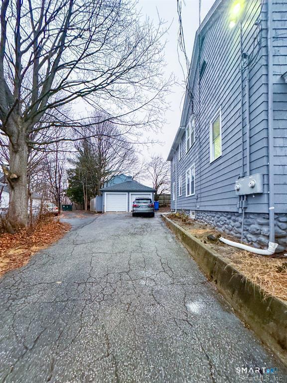 23 Lake Street Waterbury, CT 06708 - Photo 16 of 17 a front view of a house with a yard and garage