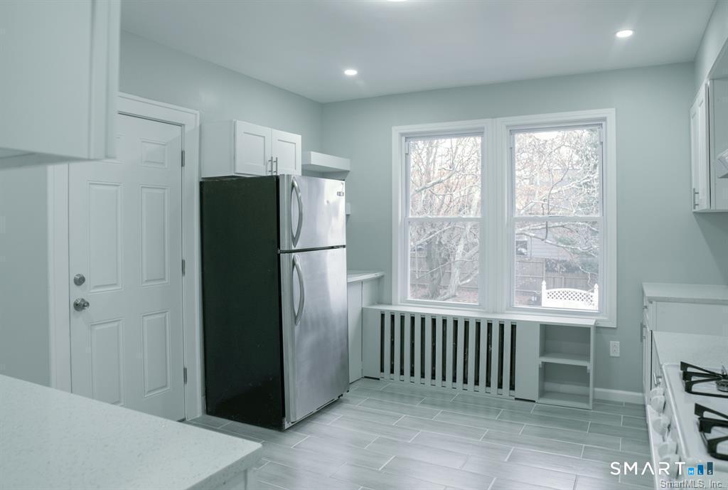 23 Lake Street Waterbury, CT 06708 - Photo 2 of 17 a view of a kitchen with a refrigerator and window