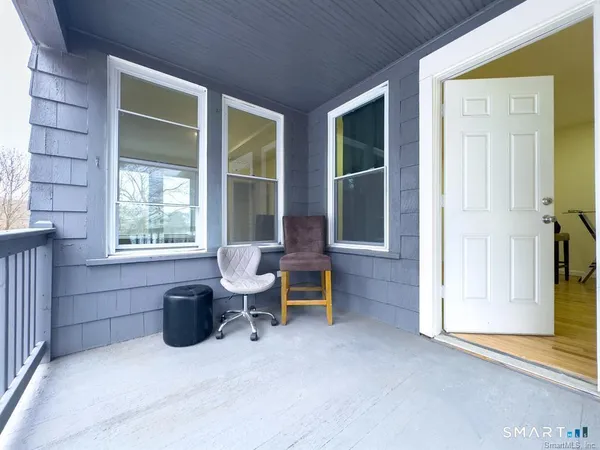 a view of a patio with chairs and a table