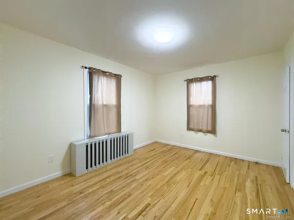 a view of a room with wooden floor